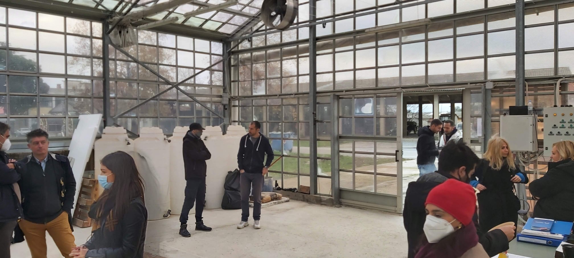 Visit to the project facilities. The indoor area (greenhouse) with the visitors is depicted